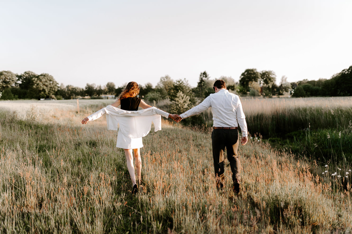 Paar geht Hand in Hand in Sonnenuntergang